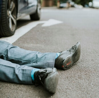 person-lying-on-the-ground-after-a-car-accident-2021-08-27-00-05-35-utc
